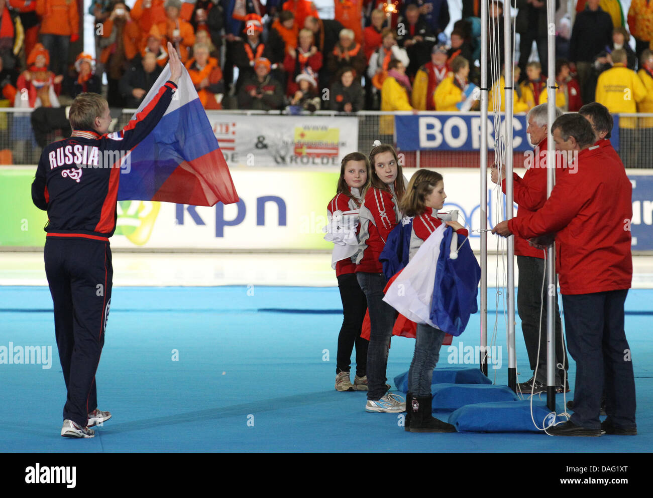 The picture shows the Russian Skater Ivan Skobrev, who came third, holding a Russian flag after the award ceremony for the 5000m men's race at the Speed-Skating World Championship at the 'Max Aicher Arena' in Inzell, Bavaria, Germany on 11 March 2011. At the award ceremony the French flag instead of the Russian flag had been hoisted by mistake. PHOTO: FRISO GENTSCH Stock Photo