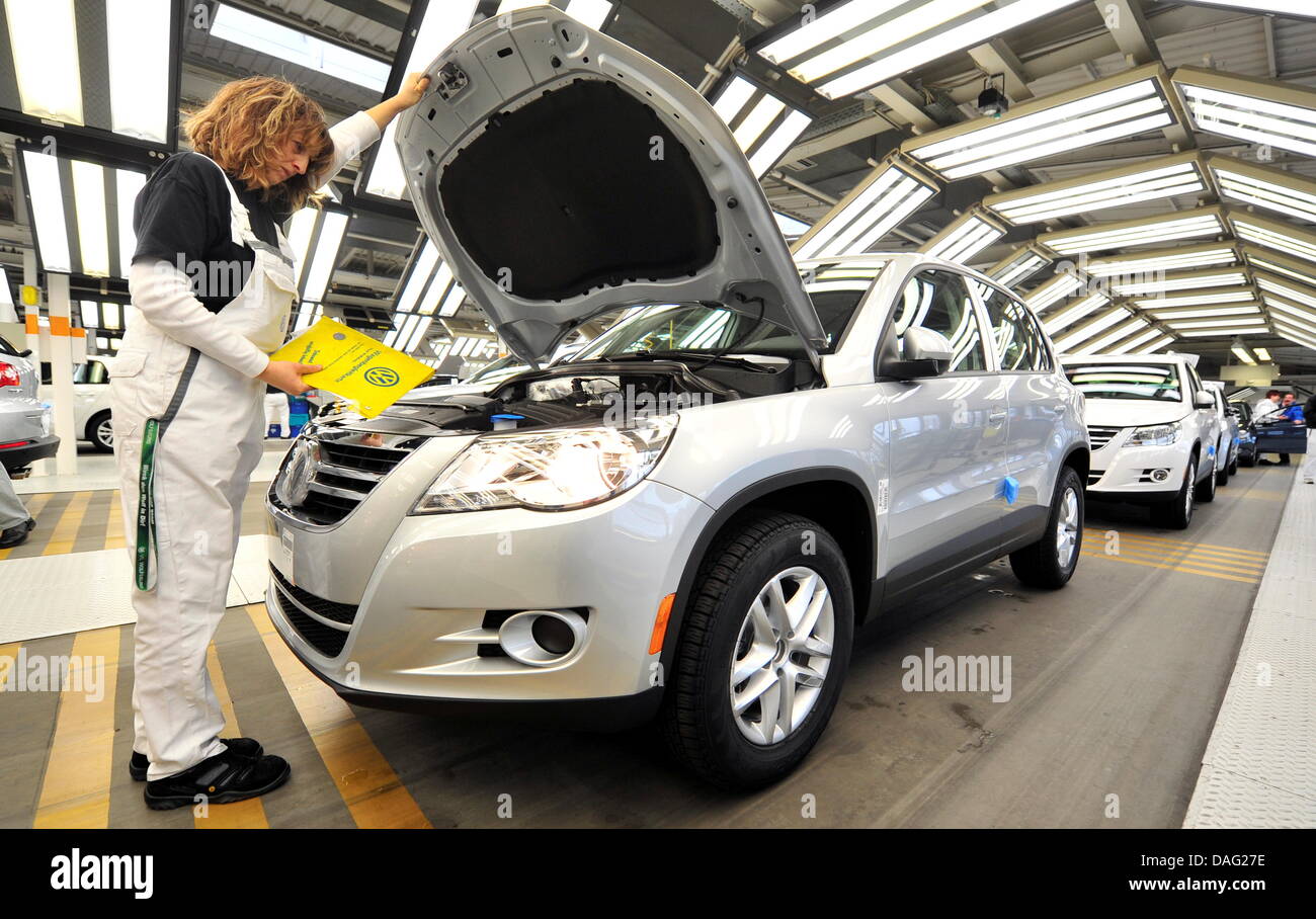 An employee of German car manufacturer Volkswagen (VW) works on a VW