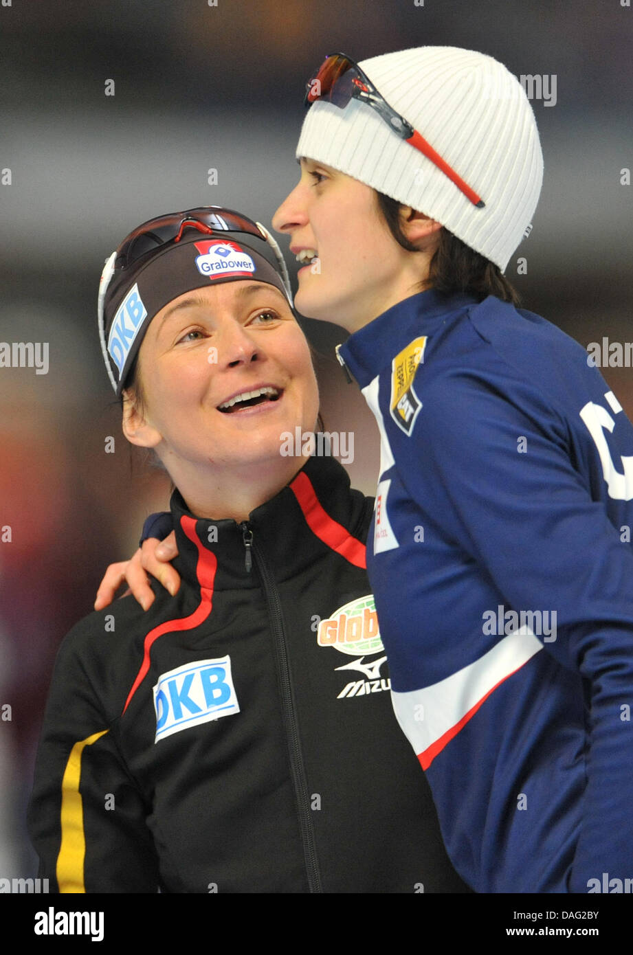 Czech speedskater Martina Sablikova cheers together with German third-place winner Claudia Pechstein (l)after the 5000 m women's race in the course of the Speedskating World Championships in Inzell, Germany, 12 March 2011. Salibovka came in first, Beckert second and Pechstein third. Photo: Friso Gentsch Stock Photo