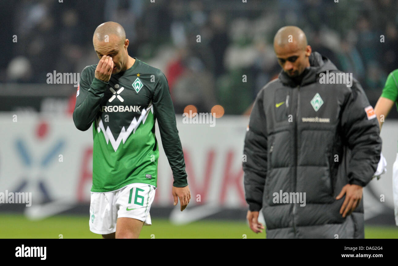 Bremen's players Mikael Silvestre (L) and Wesley walk off the pitch after the final whistle in the Bundesliga soccer match between Werder Bremen and Borussia Moenchengladbach at the Weser Stadium in Bremen, Germany, 12 March 2011. Photo: Carmen Jaspersen Stock Photo