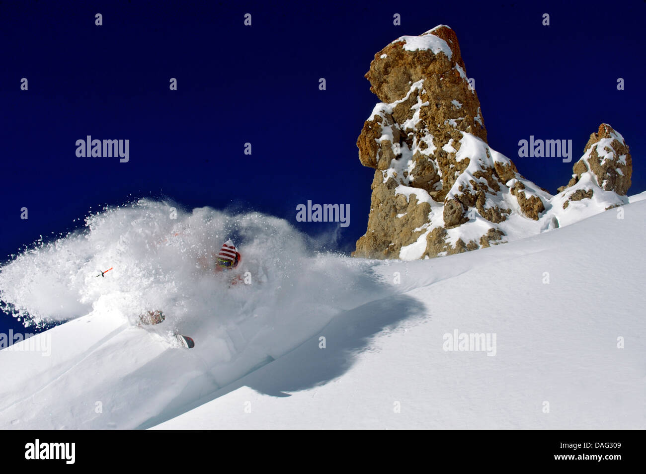 ski-runner at mountain slope in front of a bizarrely shaped rocks at Tignes ski ressort, France, Savoie, Tarentaise Stock Photo