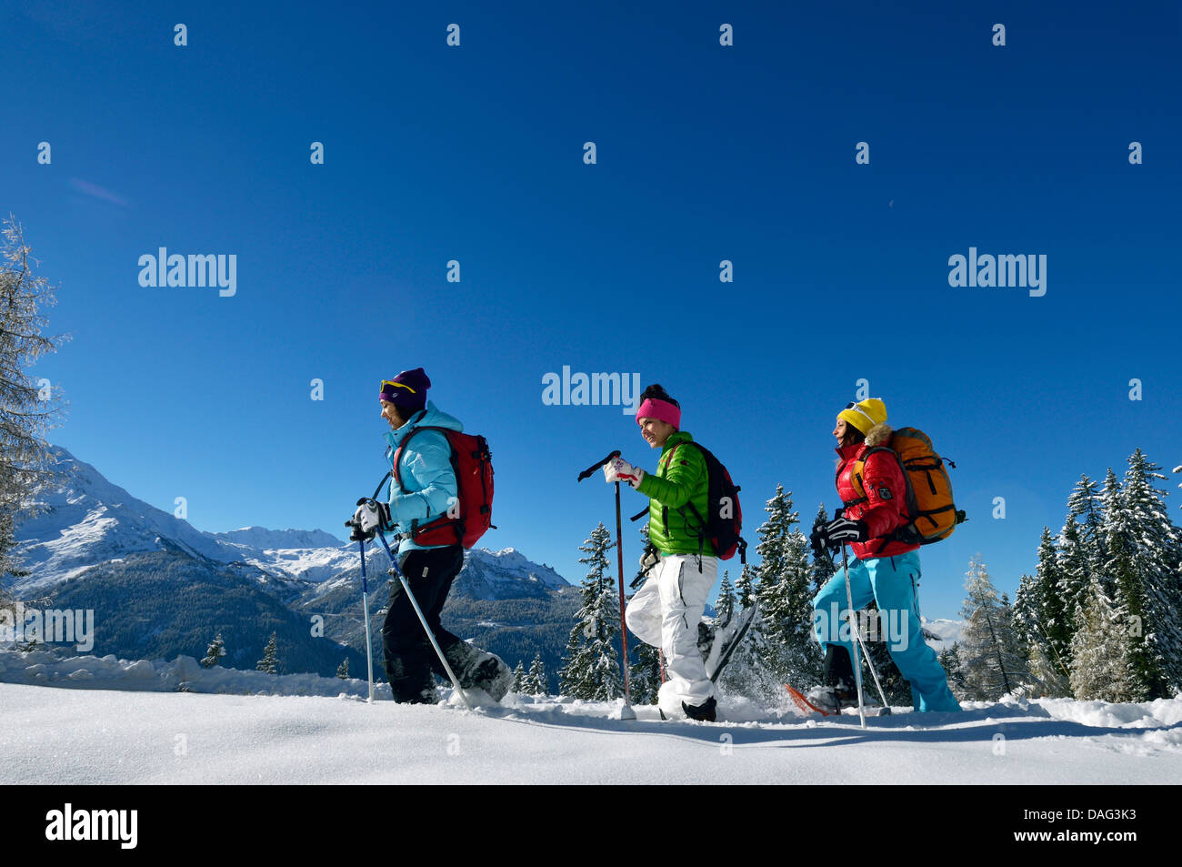 three teenage girls snowshoeing, France Stock Photo