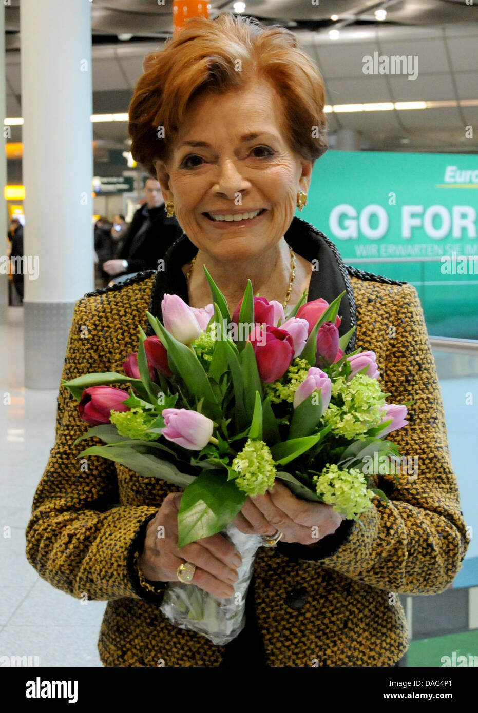 Swiss singer Lys Assia (87), the first Grand Prix winner from 1956, poses with flowers at the airport in Duesseldorf, Germany, 18 March 2011. Assia talked about her Grand Prix de la Eurovision song contest experience during a press conference with the mayor of Duesseldorf, Elbers. Photo: Horst Ossinger Stock Photo