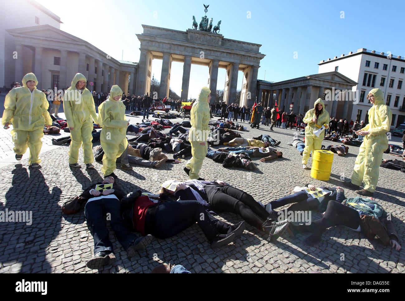 The 'victims' of a ficticious nuclear accident perform during a flashmob against nuclear energy at Pariser Platz in Berlin, Germany, 19 March 2011. 200 participants dropped to the floor and pretended to be dead at the same time after a whistle was heard. Photo: Florian Schuh Stock Photo