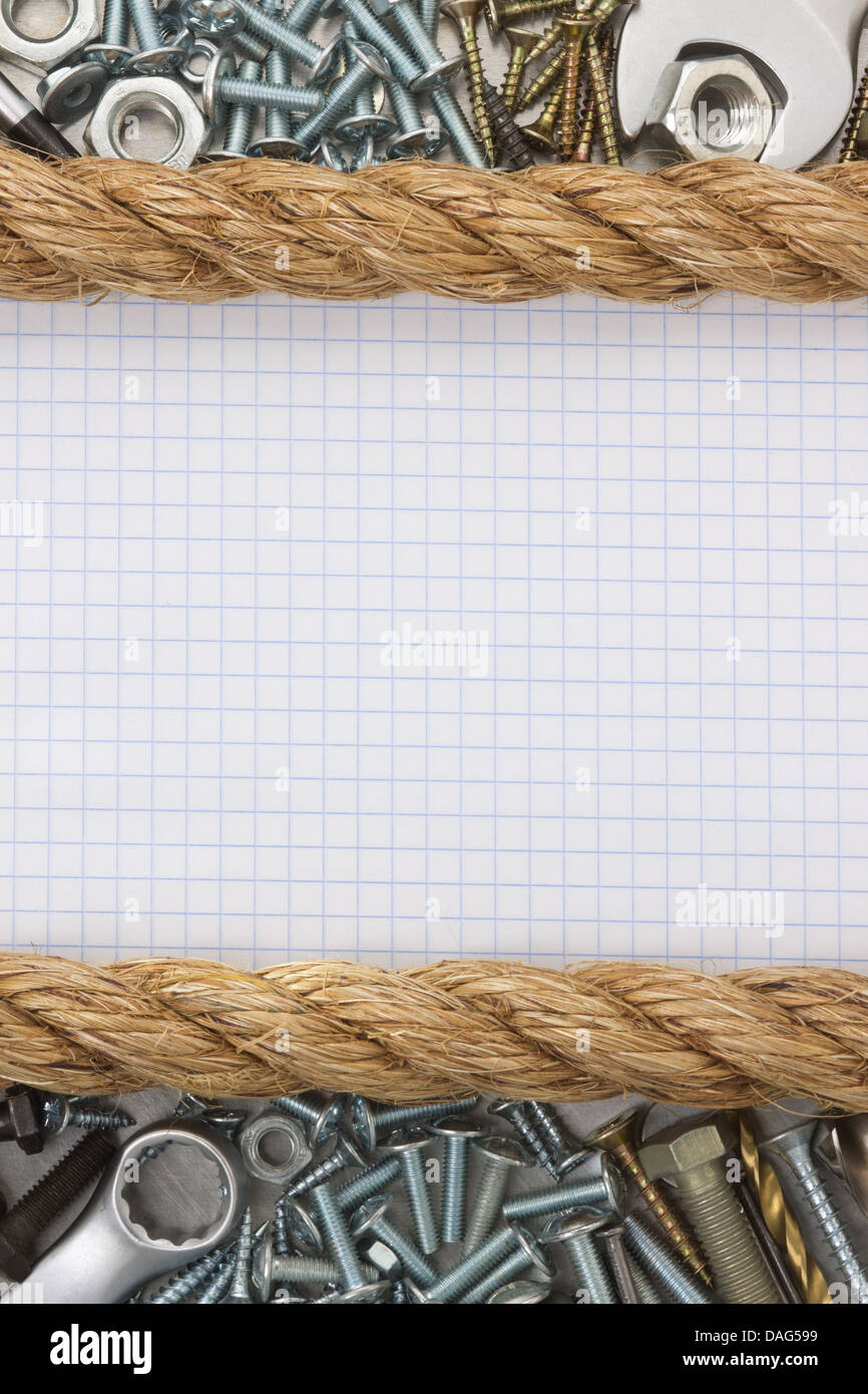 metal construction hardware tool on checked paper Stock Photo Alamy