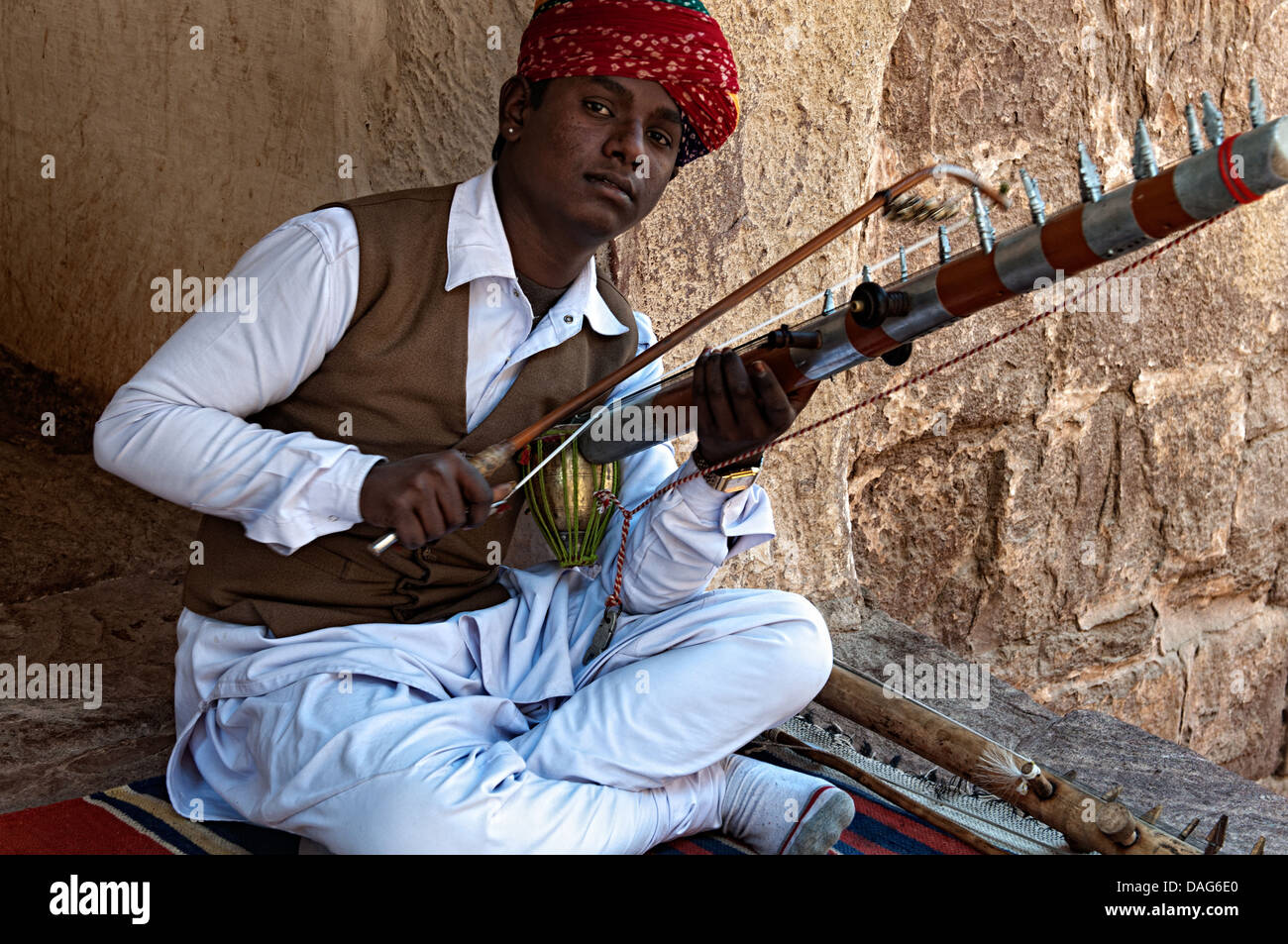 Portrait of a man playing a traditional musical instrument in ...