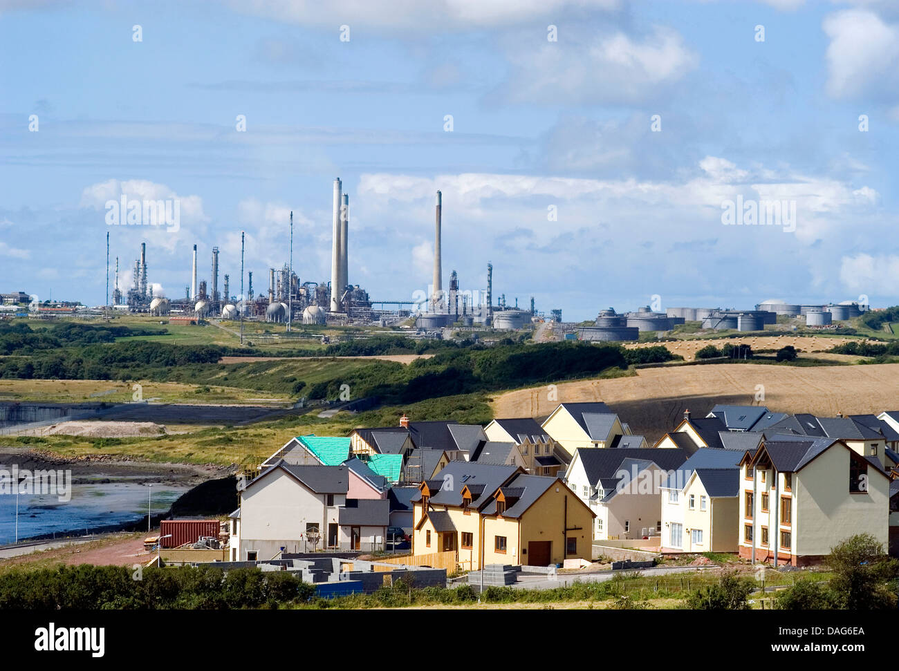 new housing estate in front of an oil refinery, United Kingdom, Wales, Pembrokeshire Stock Photo