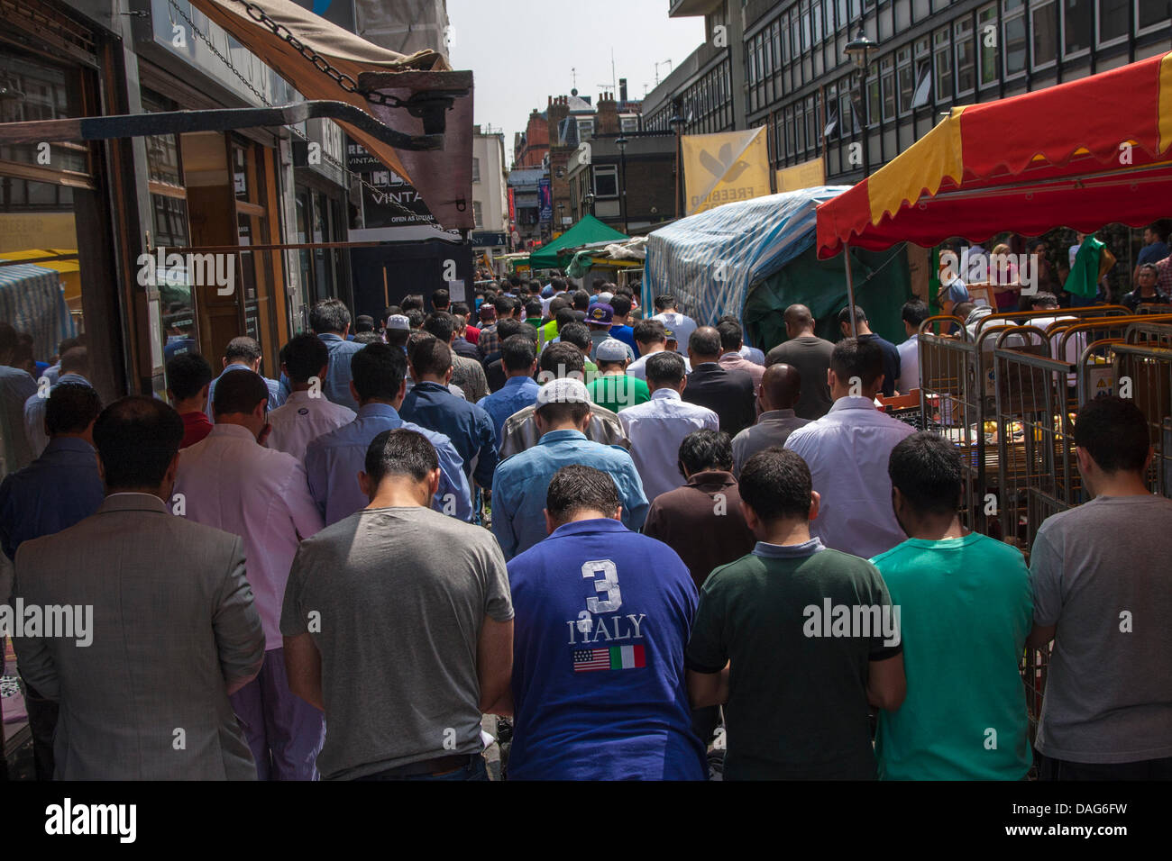 London, UK. 12th July 2013. Muslims pray on Berwick Street in Soho, London during Ramadan Credit:  Paul Davey/Alamy Live News Stock Photo
