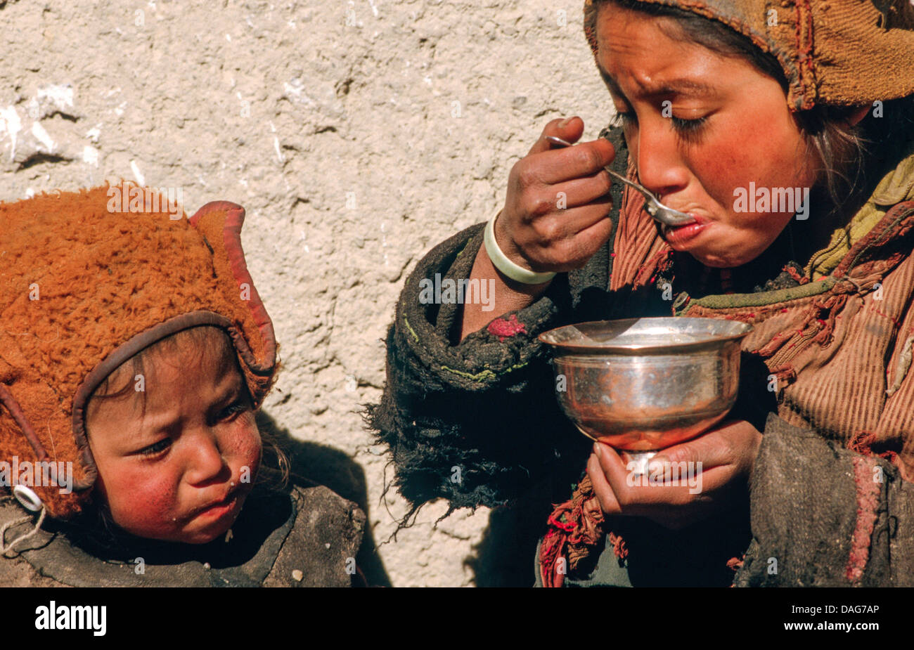 Poor children eating soup in a remote Himalayan village. Chilling