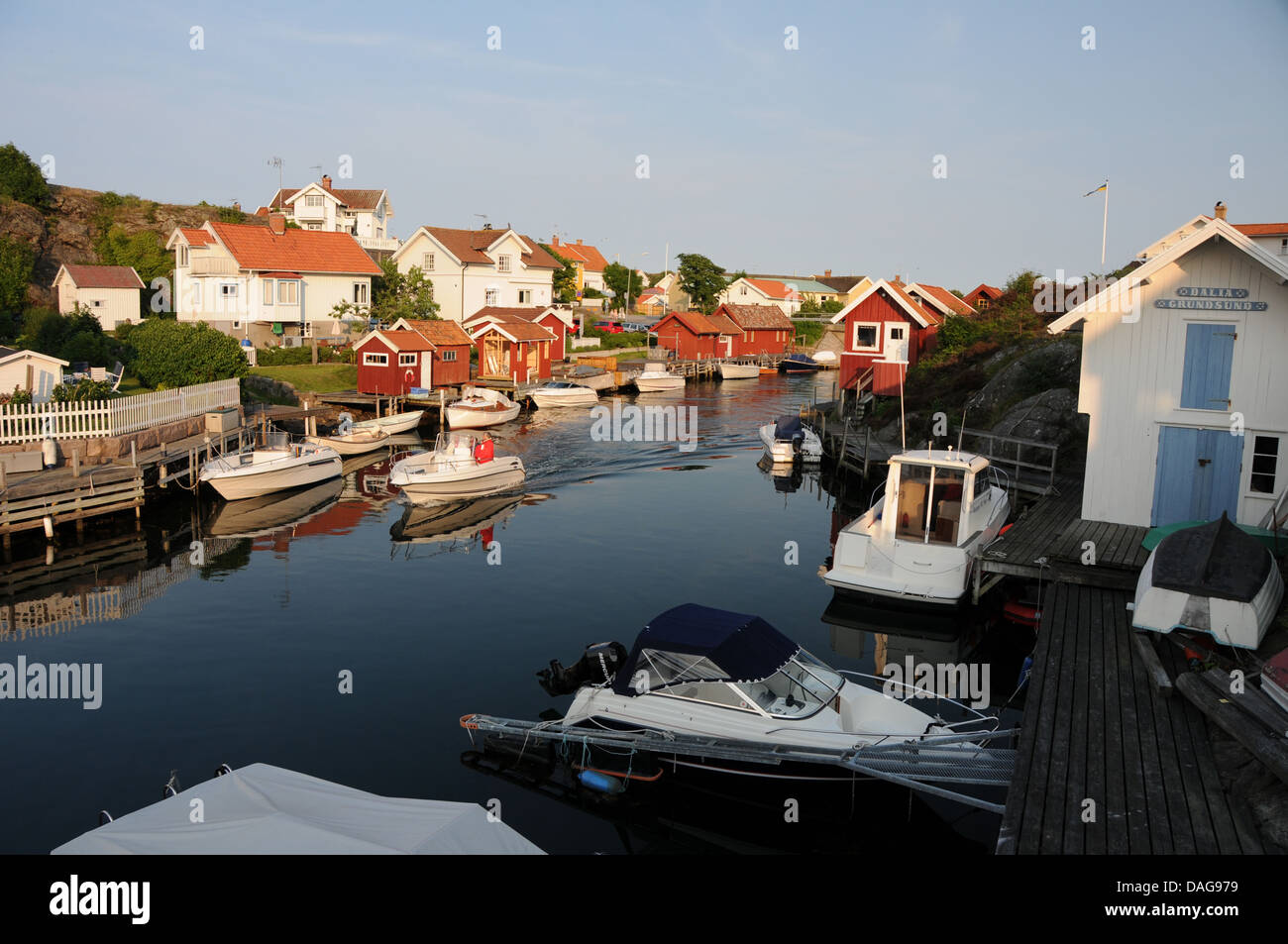 Fishing village of Grundsund on West Coast of Sweden with boats, homes, wooden docks and boathouses Stock Photo