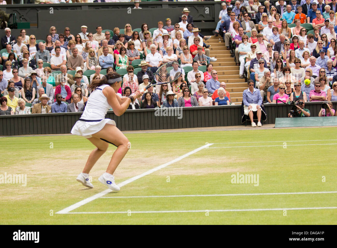 Marion Bartoli hitting the ball at the Wimbledon semi-finals against Kirsten Flipkens Stock Photo