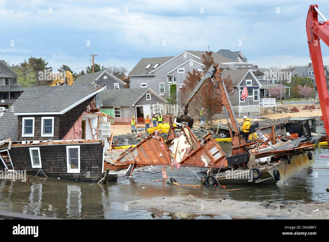 Workers demolish a home destroyed by Hurricane Sandy May 9, 2013 in Mantoloking, New Jersey. Stock Photo