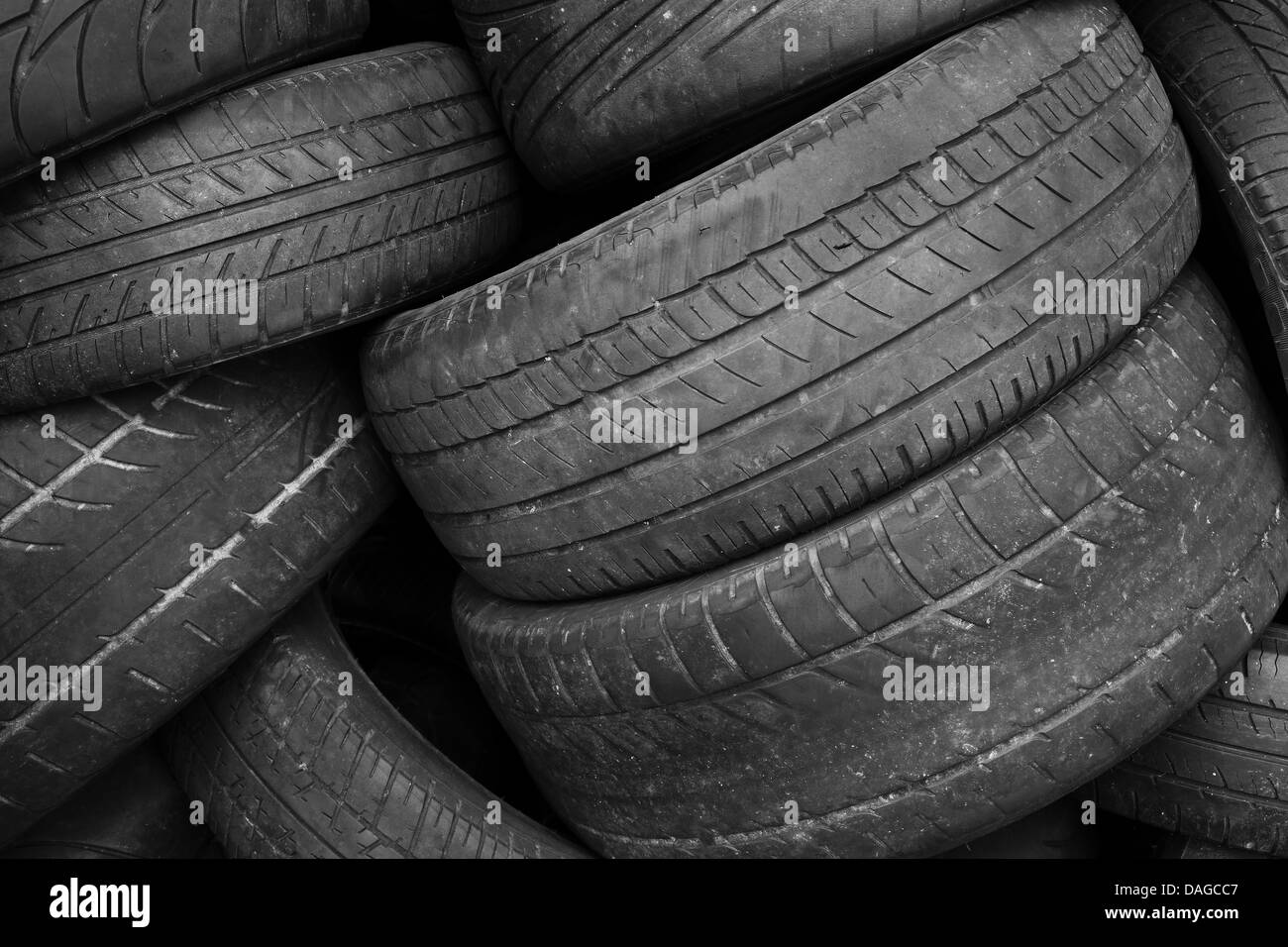 Pile of old worn out tires in black and white Stock Photo