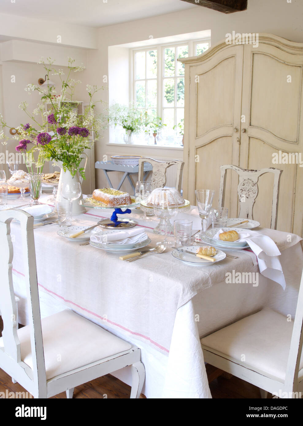 White Linen Cloth On Table Set For Lunch In White Country Dining