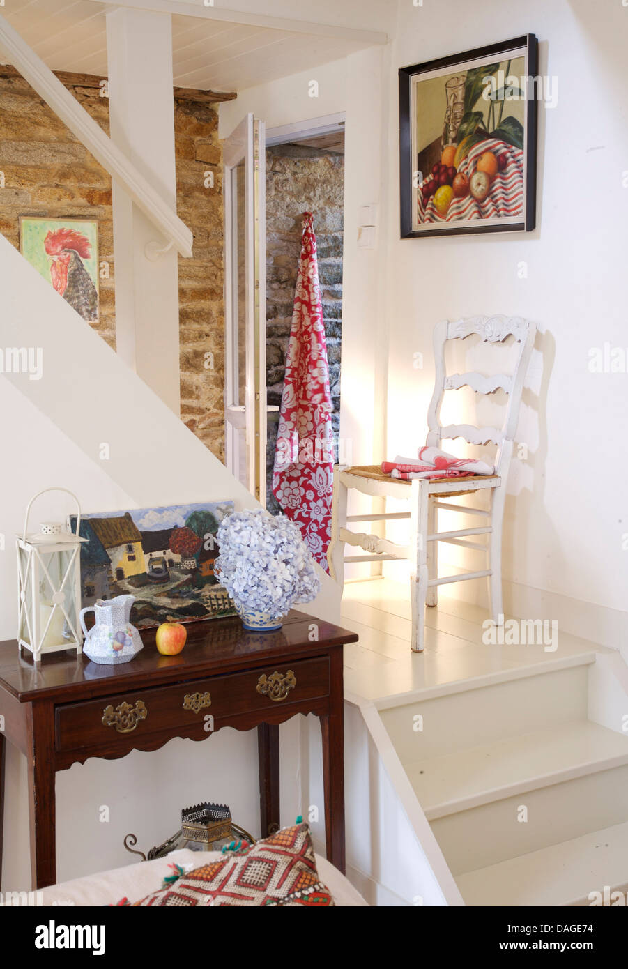 Hand-painted decoration on double doors in traditional with rush-seated  ladder-back chair and terracotta tiled floor Stock Photo - Alamy