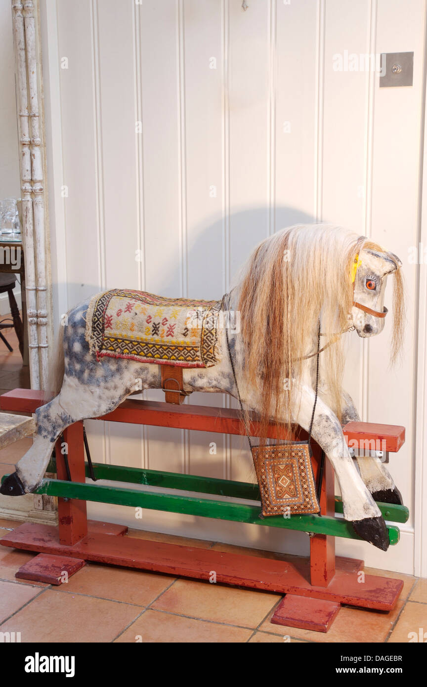 Close-up of traditional handmade wooden rocking horse with real horse hair mane and upholstered saddle Stock Photo