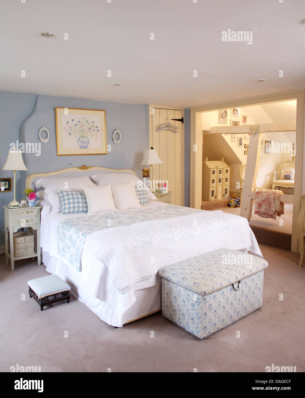 Blue White Ottoman Below Bed With White Linen And Blue
