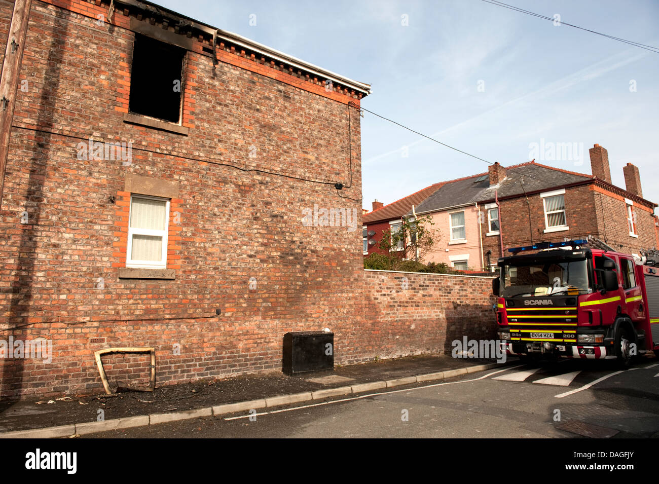 Fire Engine Truck at House Fire Burnt out Gutted Bedroom Window Stock Photo