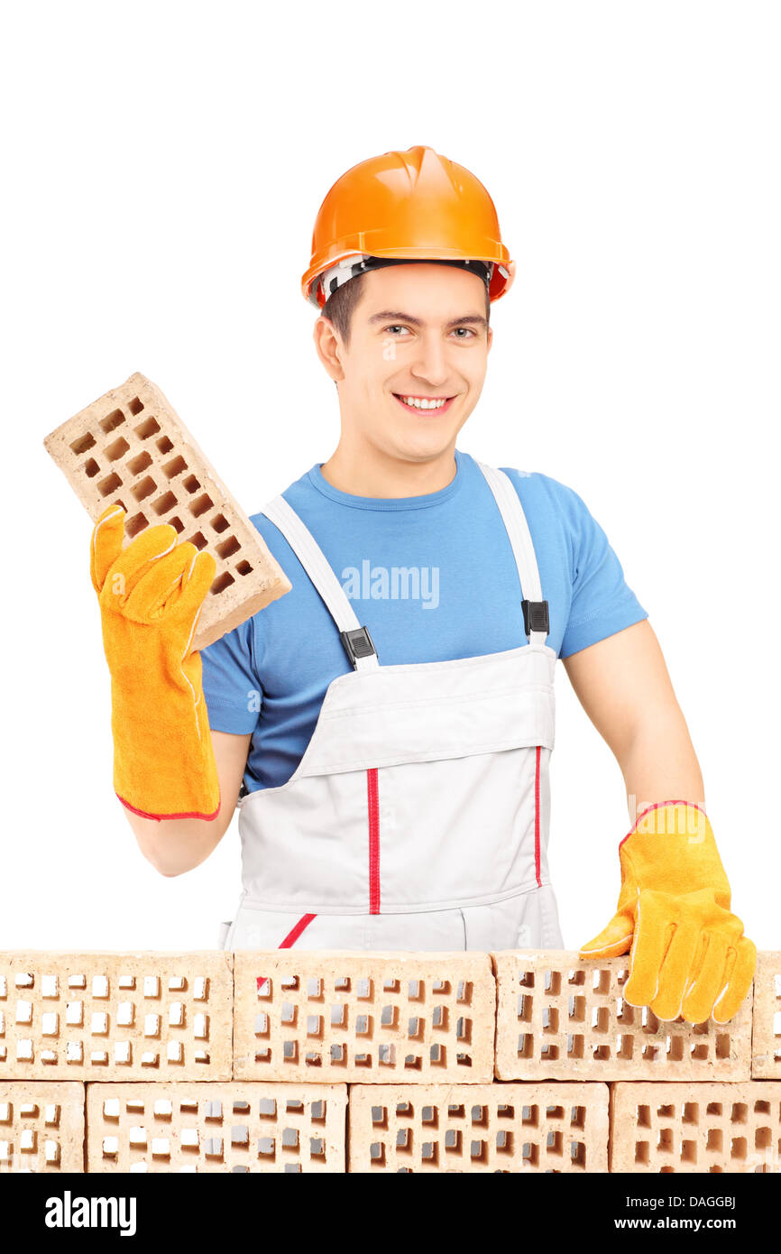 Smiling male builder building a brick wall Stock Photo - Alamy