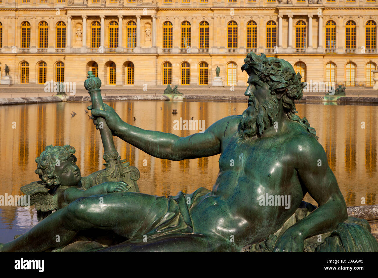Reclining statue beside pool at Chateau de Versailles, France Stock Photo