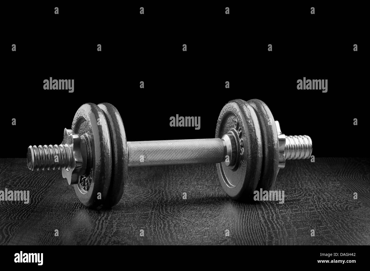Exercise weights on a dark wooden deck. Stock Photo