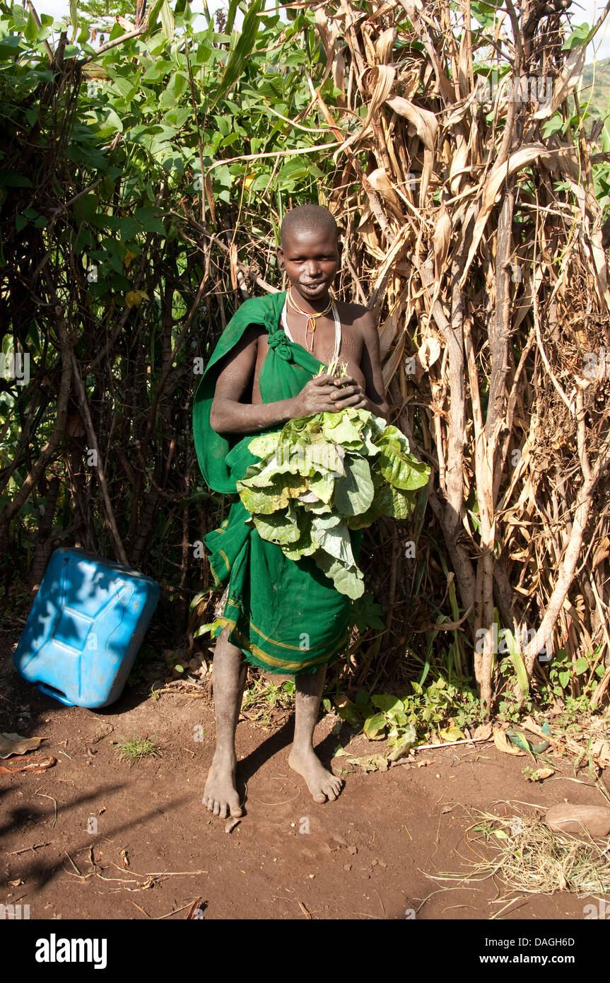 A young Suri (Surma) woman with tobacco leaves, Ethiopia Stock Photo