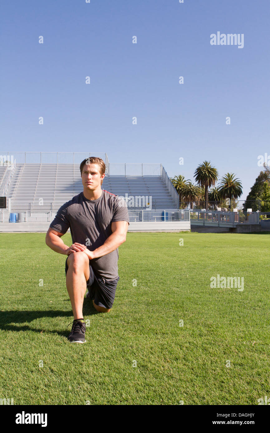 A Caucasian man in his twenties works out at a stadium. Stock Photo