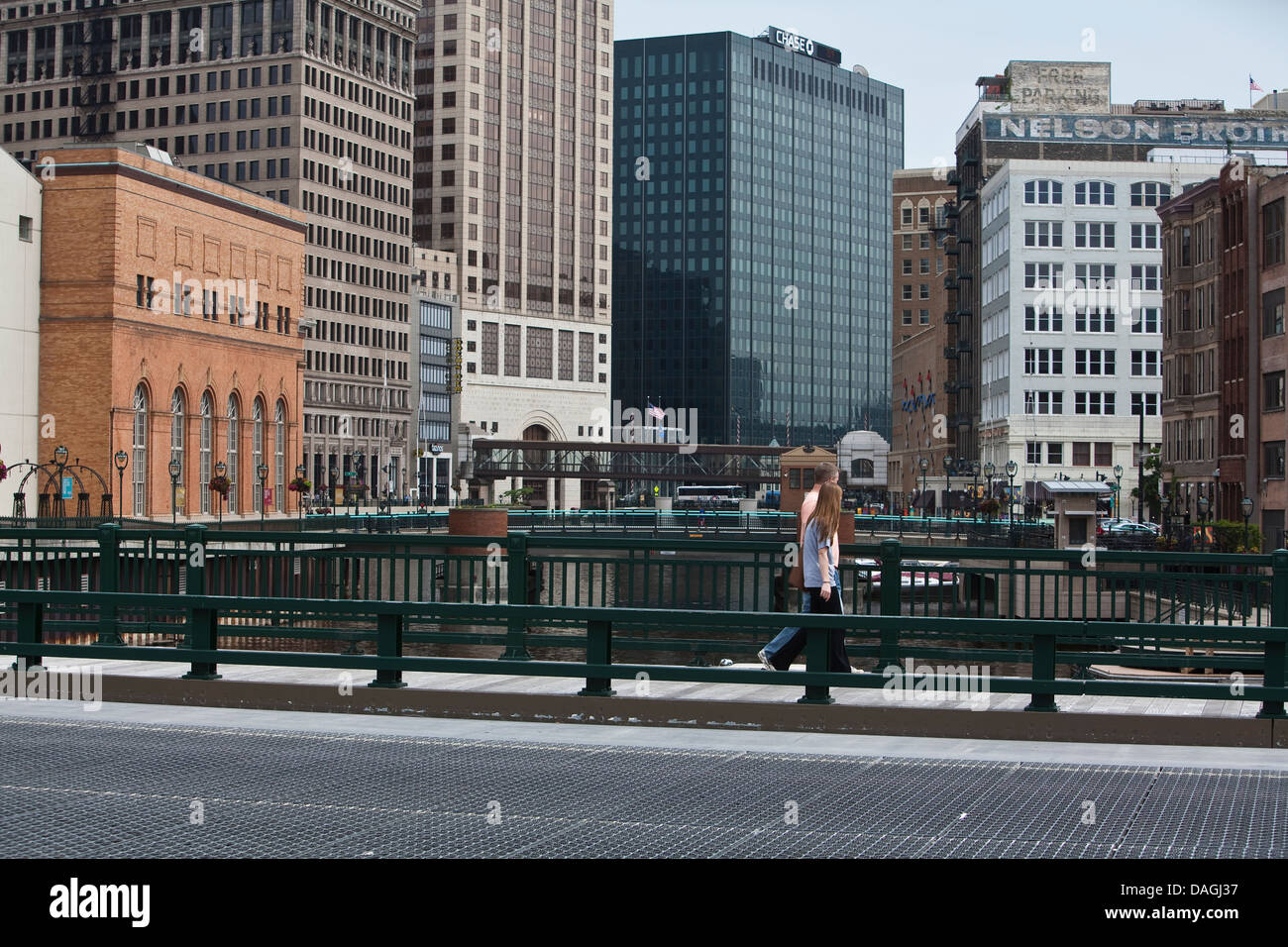 A man and a woman walk on a movable bridge in Milwaukee Stock Photo