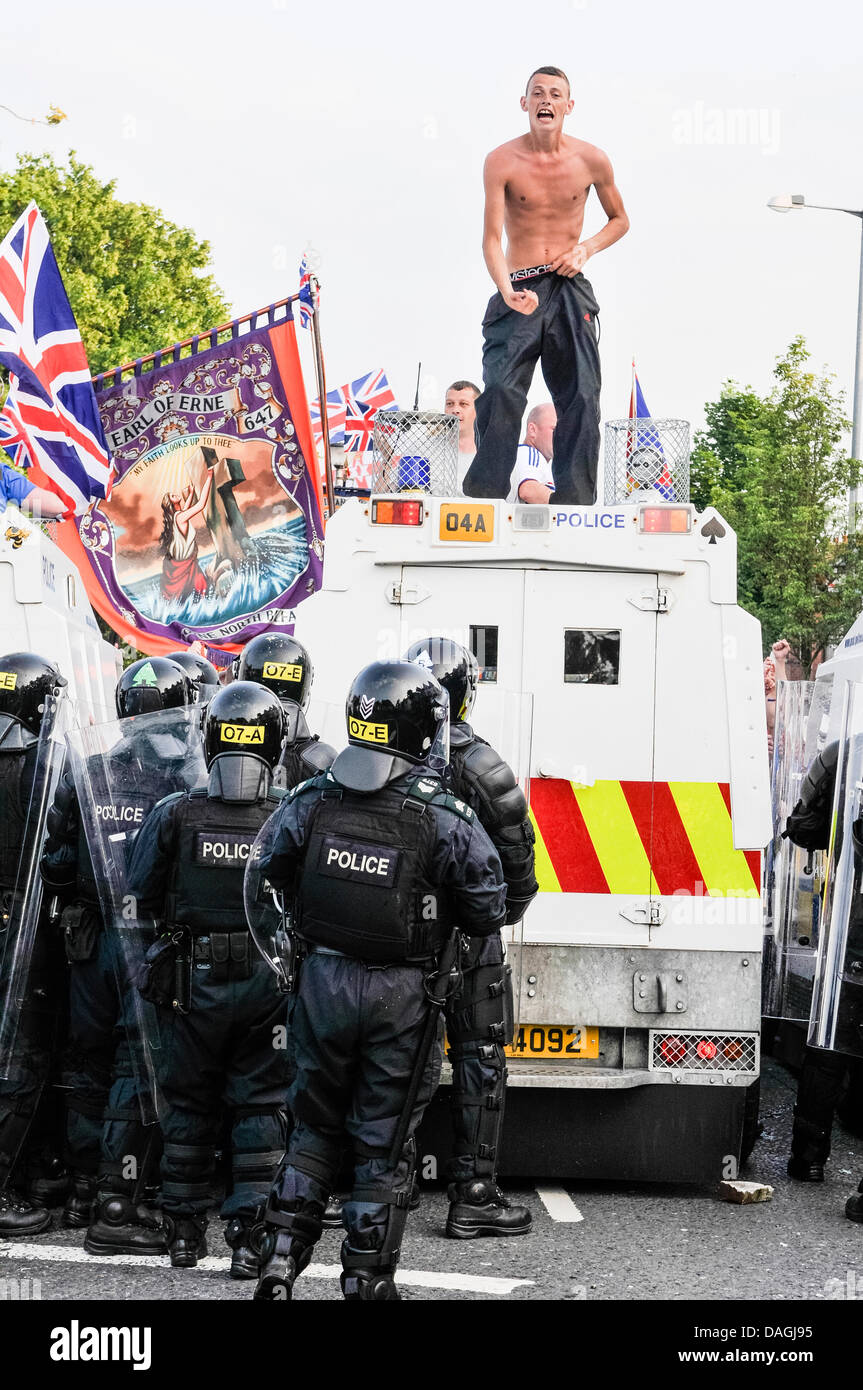 Belfast, Northern Ireland, 12th July 2013 - A protester makes an obscene gesture towards police after he climbs onto a PSNI landrover Credit:  Stephen Barnes/Alamy Live News Stock Photo