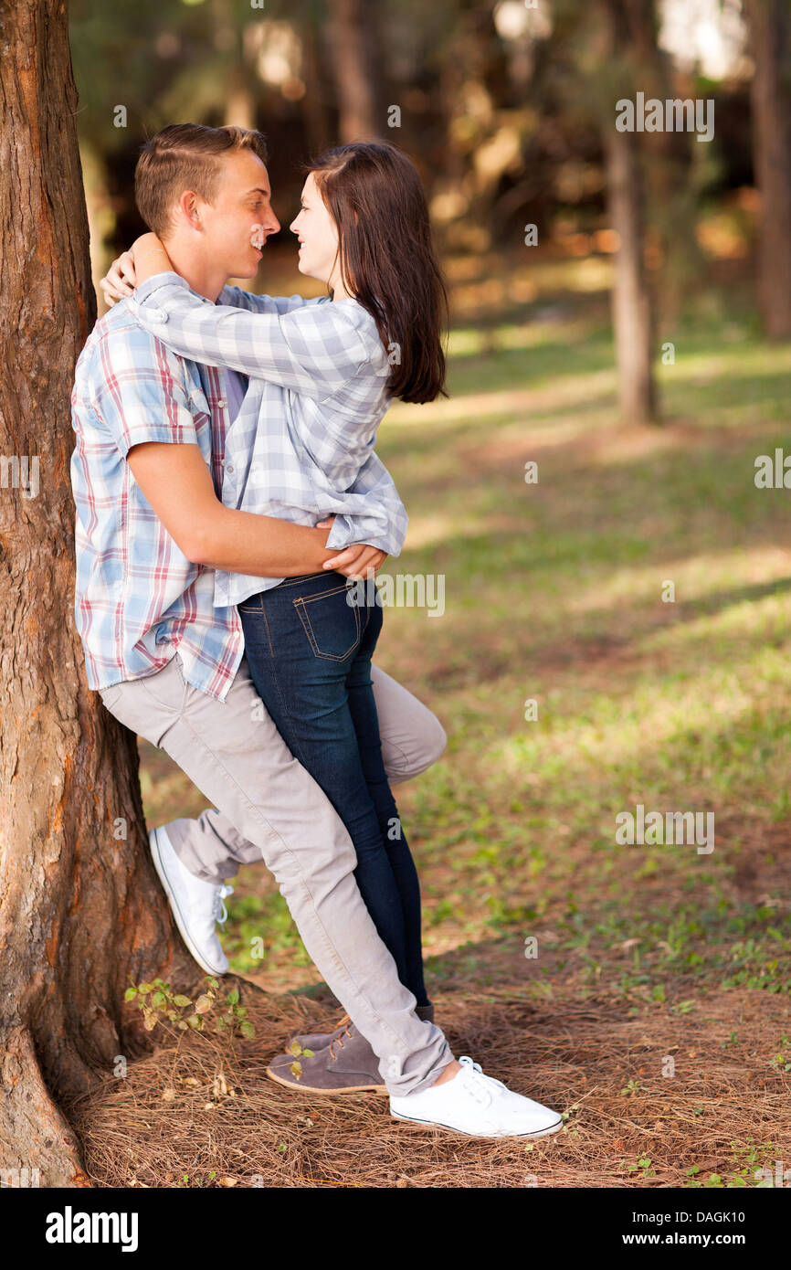 romantic teenage couple embracing outdoors Stock Photo