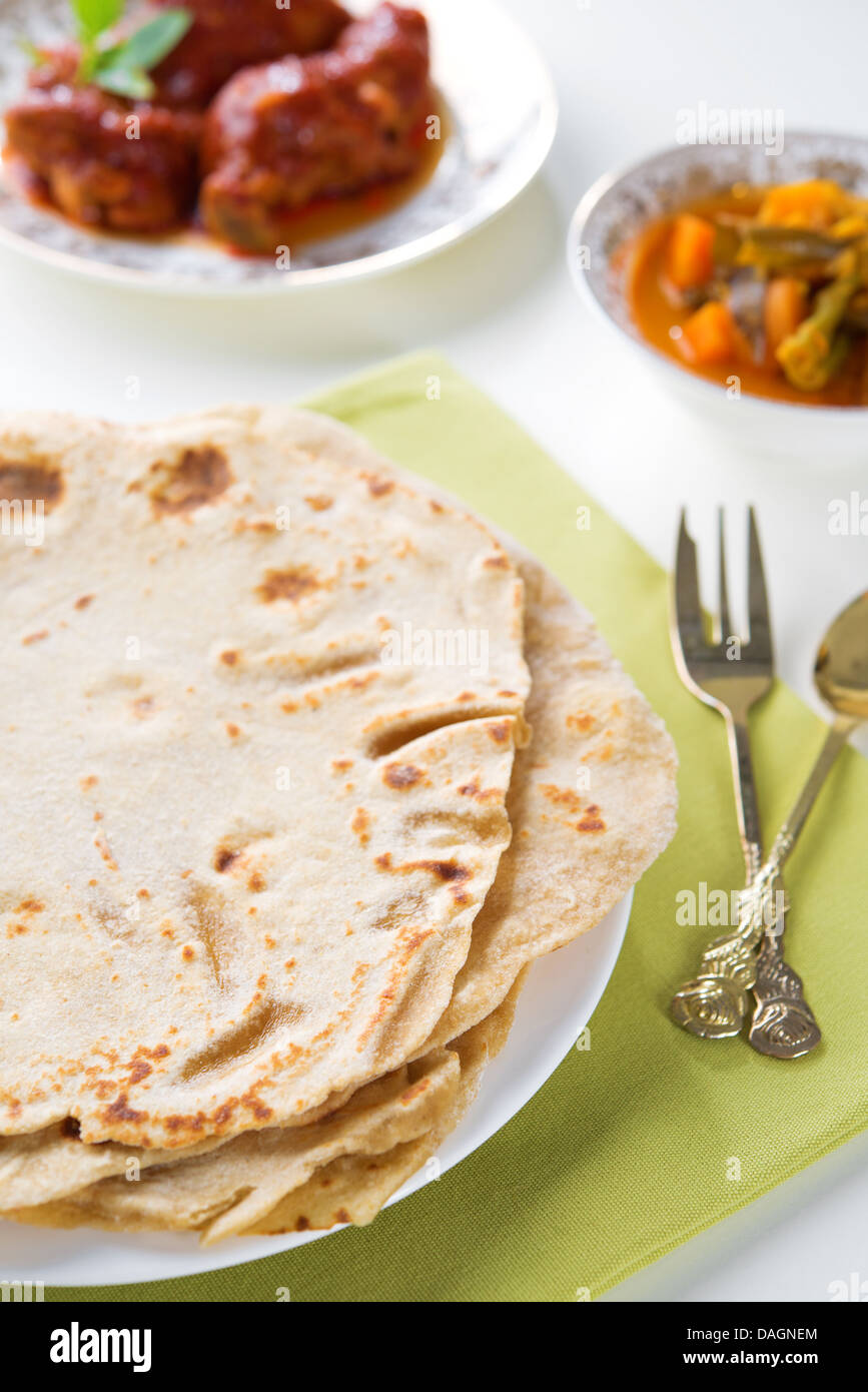 Chapatti roti or Flat bread, curry chicken and dhal. Indian food on