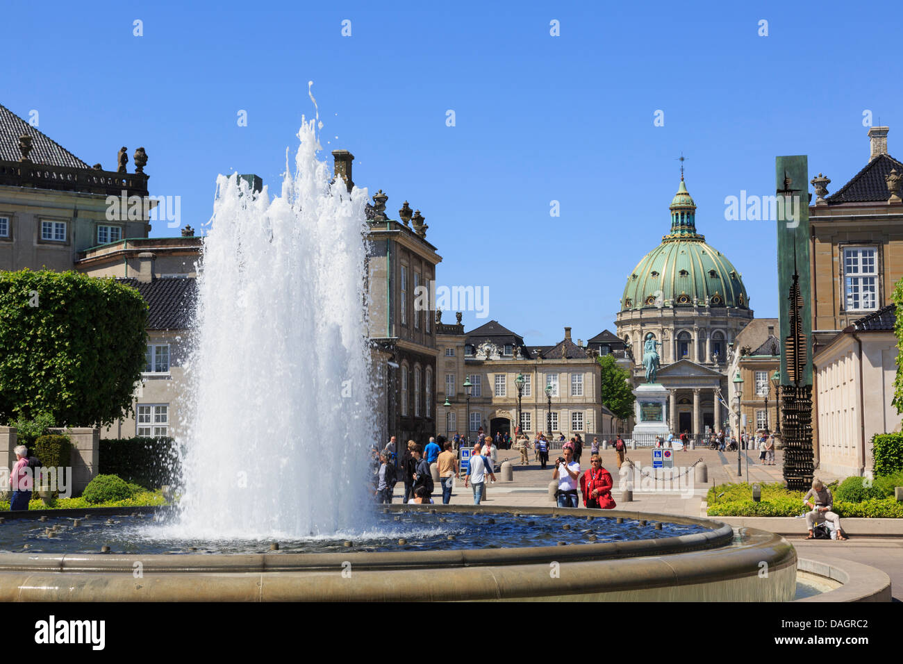 Fountain in Amaliehaven or Amalie Gardens on waterfront with Amalienborg or Royal Palace and Marble Church in Copenhagen Denmark Stock Photo