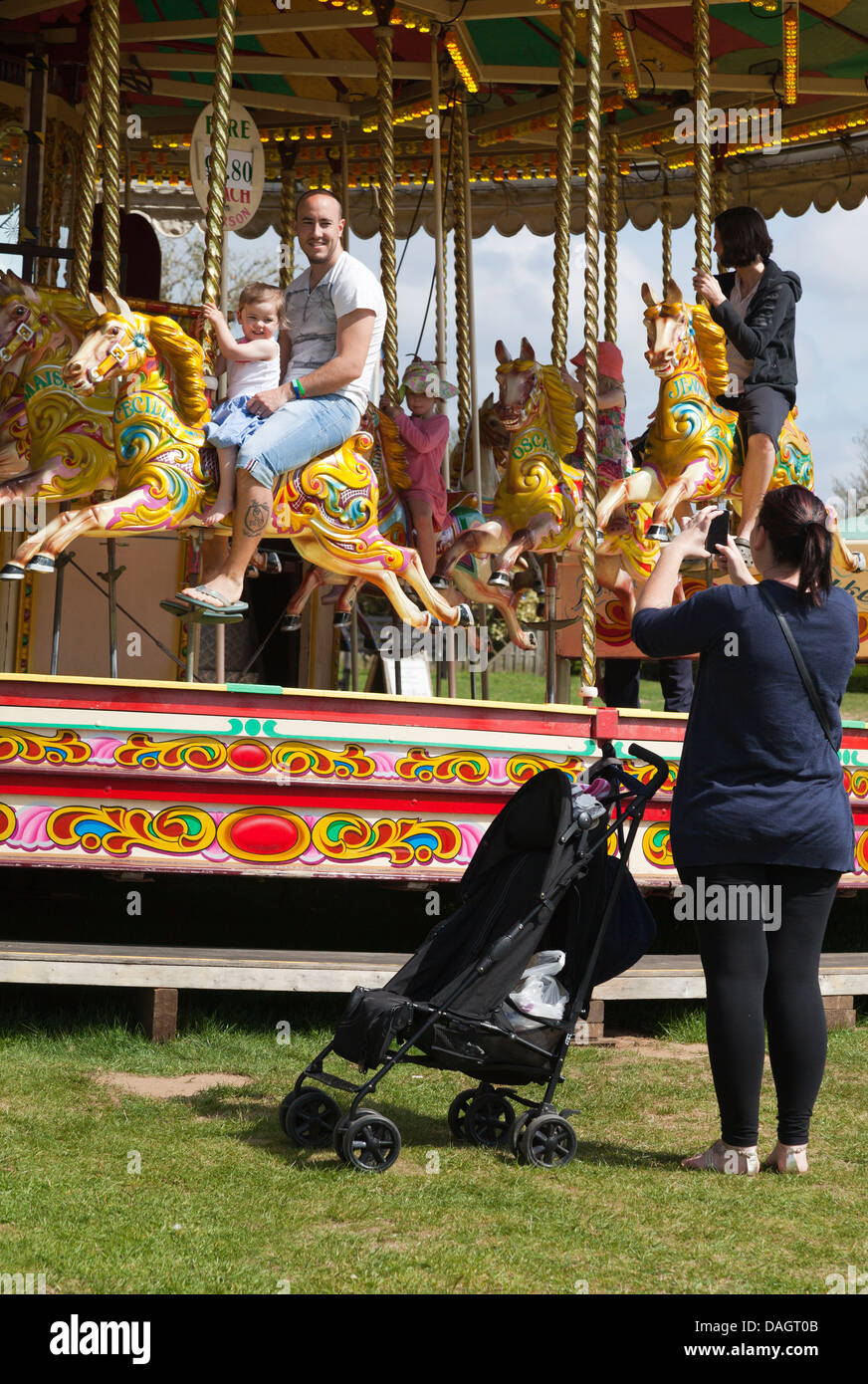 Snapping the family at a merry-go-round in Millets Farm, Oxford Stock Photo
