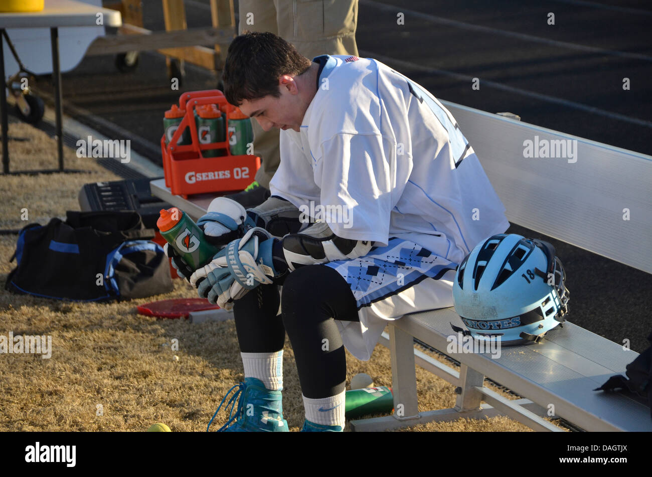 A lacrosse player rests after a rough game Stock Photo