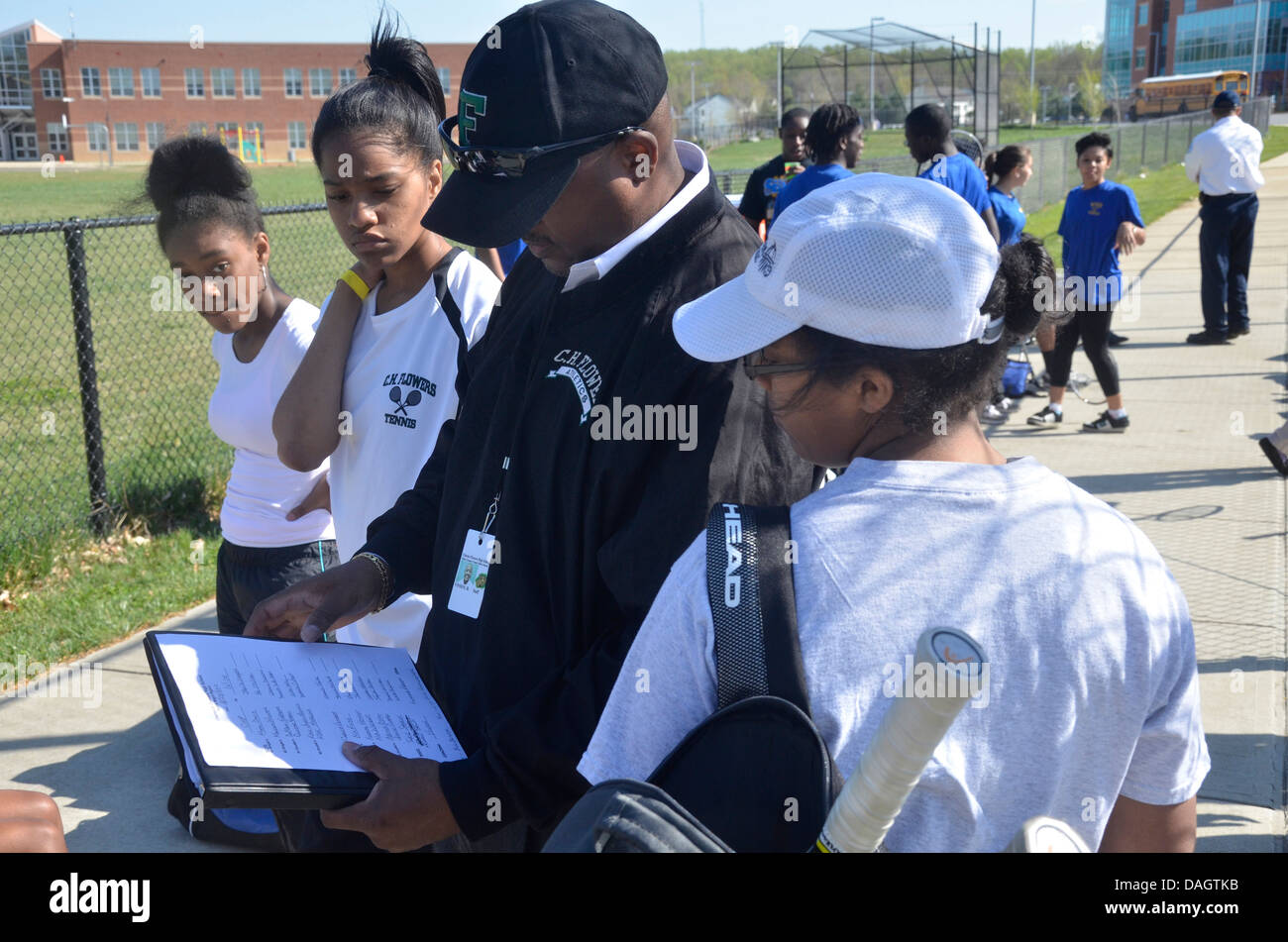 coach talking to his high school tennis players before their match