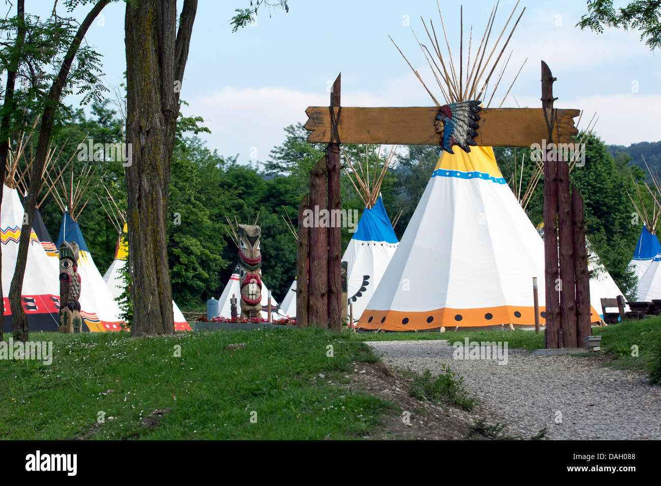 Entrance to the Indian village with tepees and totems. Stock Photo