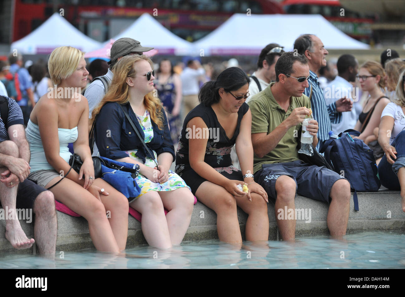 Trafalgar Square, London, UK, 13th July 2013. Keeping cool in the water of the fountains at the 'Get Reading' event in Trafalgar Square. Credit:  Matthew Chattle/Alamy Live News Stock Photo