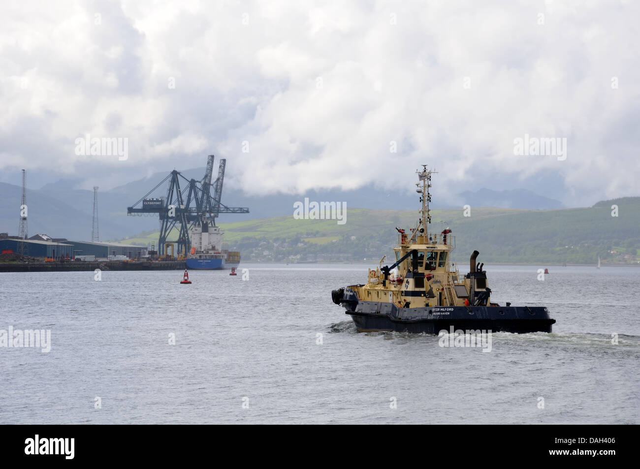 A tug boat heading down the river Clyde to the Clydeport in Greenock