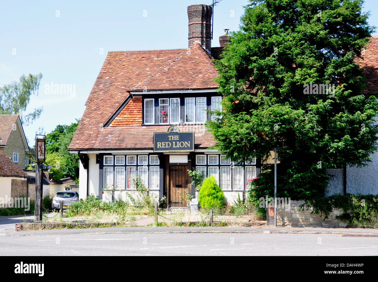 Bucks - Haddenham - a village pub - closed down - weeds in the garden - overgrown - sign of the times Stock Photo