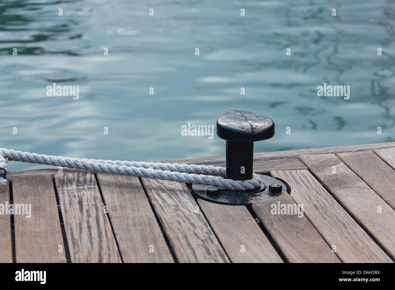 Mooring rope tied around steel anchor Stock Photo
