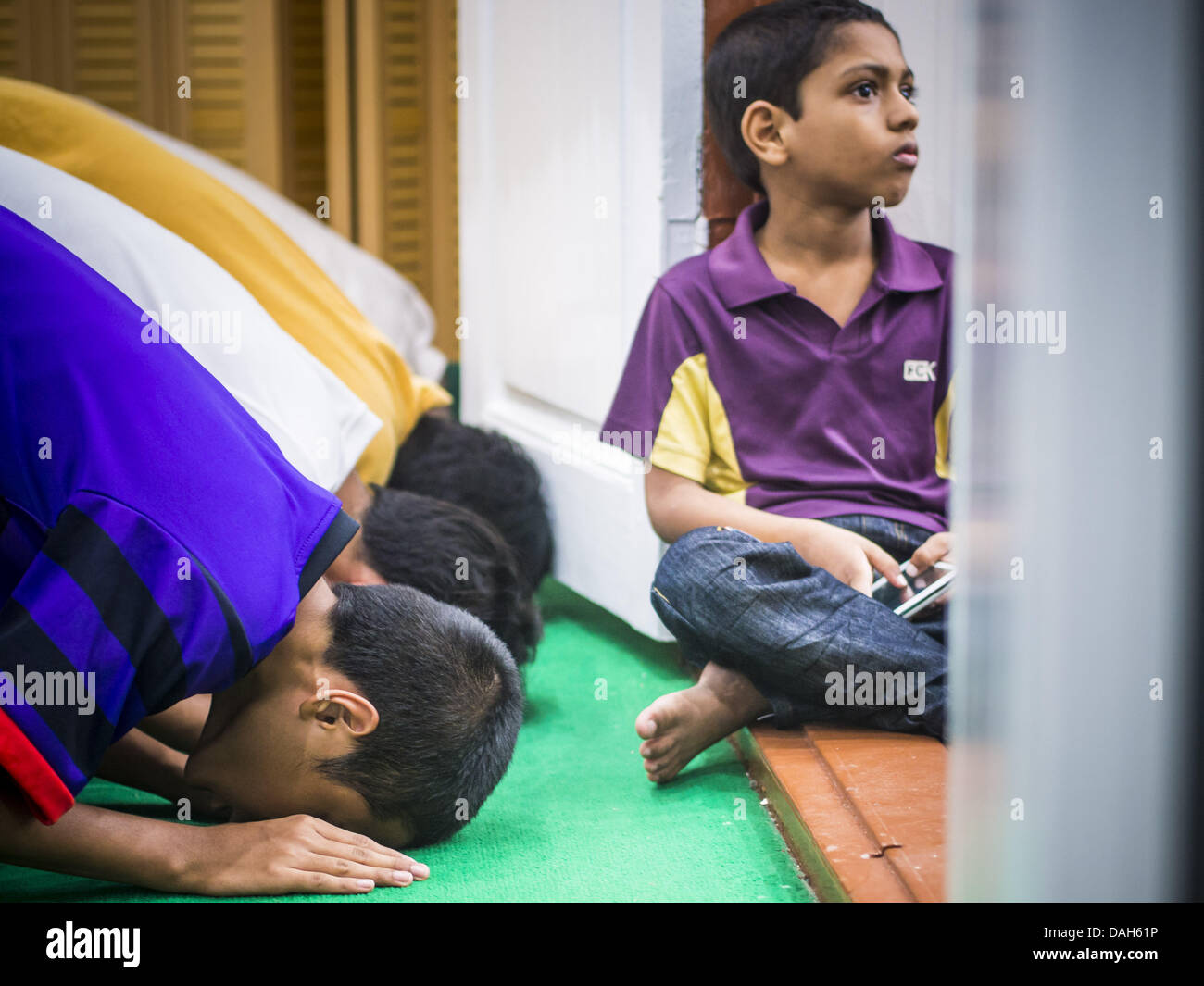 July 13 2013 Bangkok Thailand A Boy Sits In The Doorway While Men 