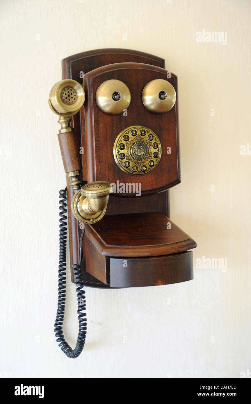 Vintage telephone hanging on a wall Stock Photo
