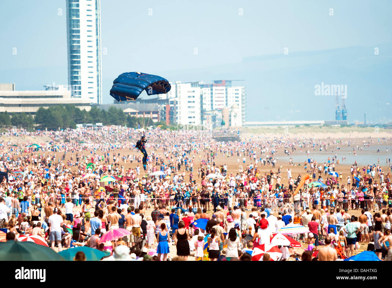 Swansea, Wales, UK. 13th July 2013. A parachute lands on the beach at the 2013 Wales National Airshow on a very hazy summer afternoon. Credit:  Robert Convery/Alamy Live News Stock Photo