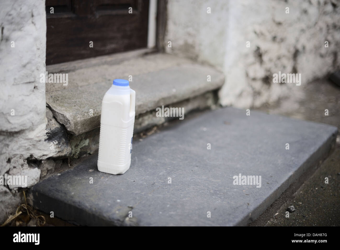 One litre plastic carton of full fat cows milk on the doorstep, Wales, UK. Stock Photo