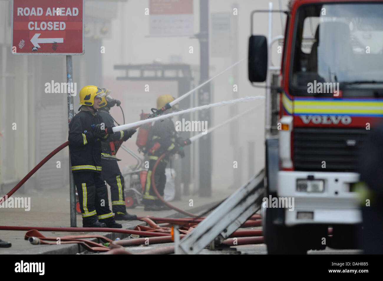 Manchester, UK. 13th July, 2013. Firefighters tackle a blaze at Paul's Hair World and NQ Life music venue on Oldham Street in the Northern Quarter area of Manchester. firefighter Stephen Hunt, 38, died tackling the fire. Two teenage girls have been arrested on suspicion of manslaughter in connection with the fire. Credit:  Russell Hart/Alamy Live News (Editorial use only). Stock Photo