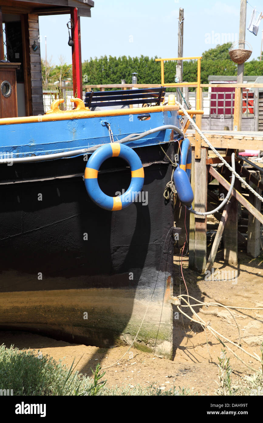 An old ship converted for use as a houseboat at Shoreham Beach, UK
