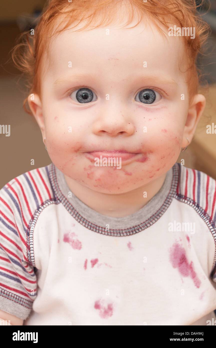 Portrait of Funny Baby With Dirty Face After Eating Stock Photo