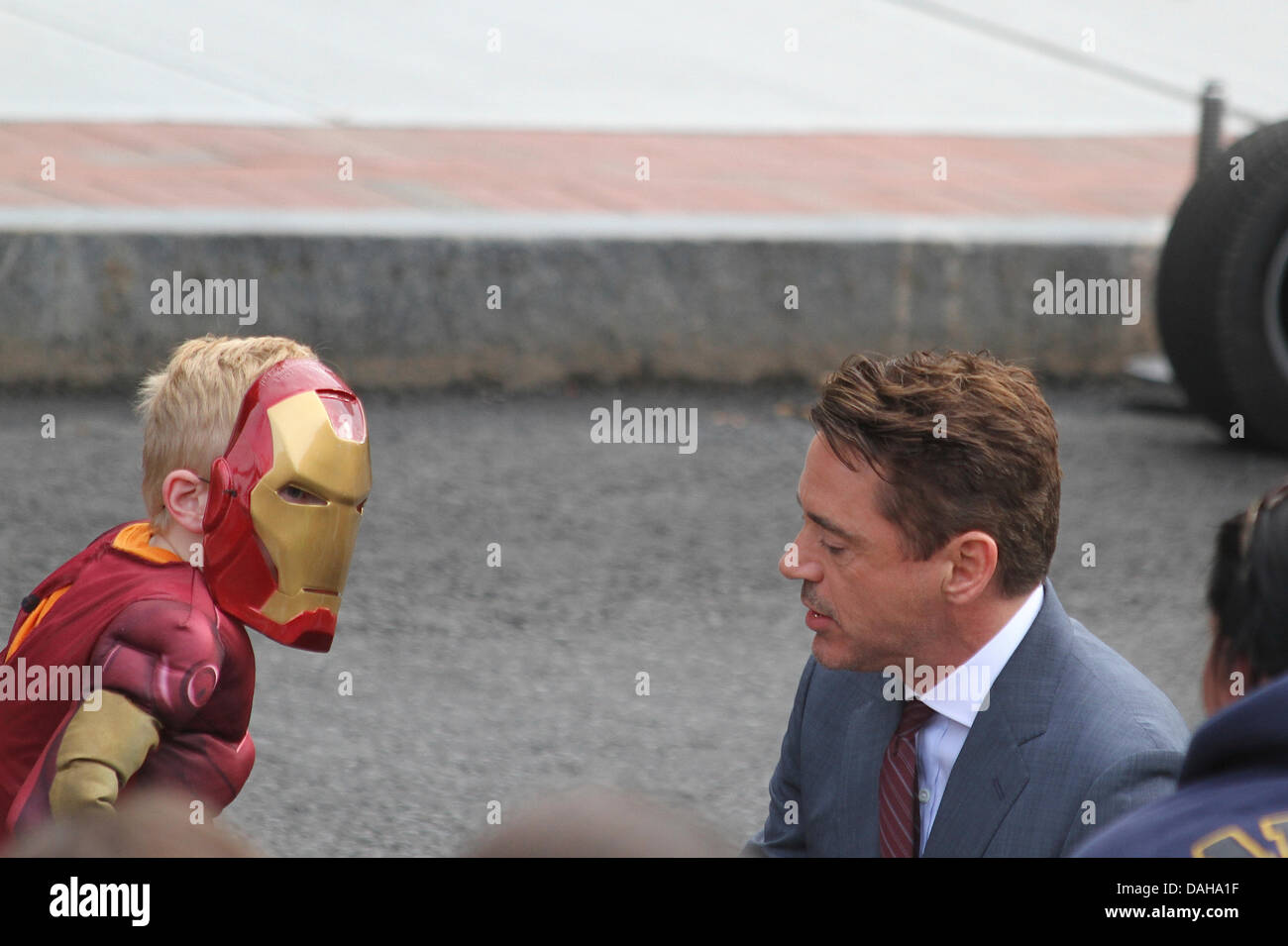 Dedham, Massachusetts. Robert Downey Jr talks to a boy in an 'Iron Man' mask and costume on the set of 'The Judge' in Dedham, Massachusetts, on July 12, 2013 Credit:  Susan Pease/Alamy Live News Stock Photo