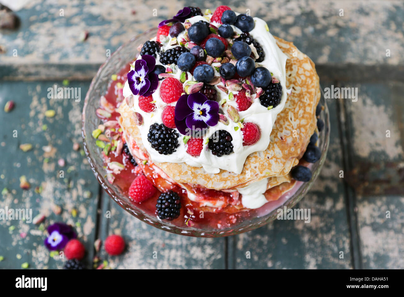 Pancake tower cake with layers of fresh cream and berry fruits viewed from above Stock Photo