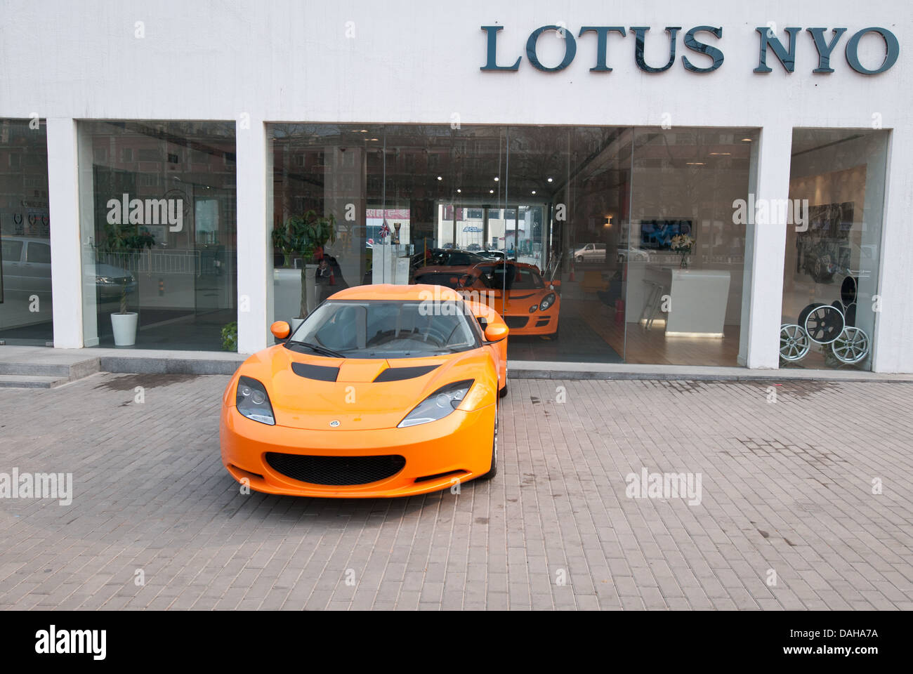 Lotus Evora in front of Lotus NYO car showroom at Workers' Stadium